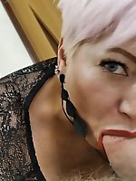 Aimee, a sexy mature woman, giving oral pleasure to a man