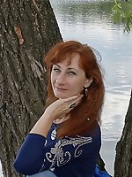 A beautiful mature woman is fondling her genital area
