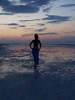 On sand seminude with light-color vase
